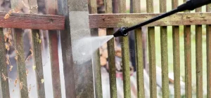 cleaning-dirty-garden-fence-post-high-pressure-washer-concrete-78254373