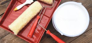 painted-tool-with-roller-paint-brush-paint-bucket-canned-paint-for-painting-on-wooden-background-top-view-on-paint-tray-photo